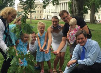 A sapling from the Tree of Guernica has been planted at the Capitol Building in Washington Rep. John Garamendi (bottom right) and his family cover the roots of an oak tree on Capitol Hill. The sapling is a descendant of a historic tree in the Basque Country. (Sarah D. Wire/ Los Angeles Times)